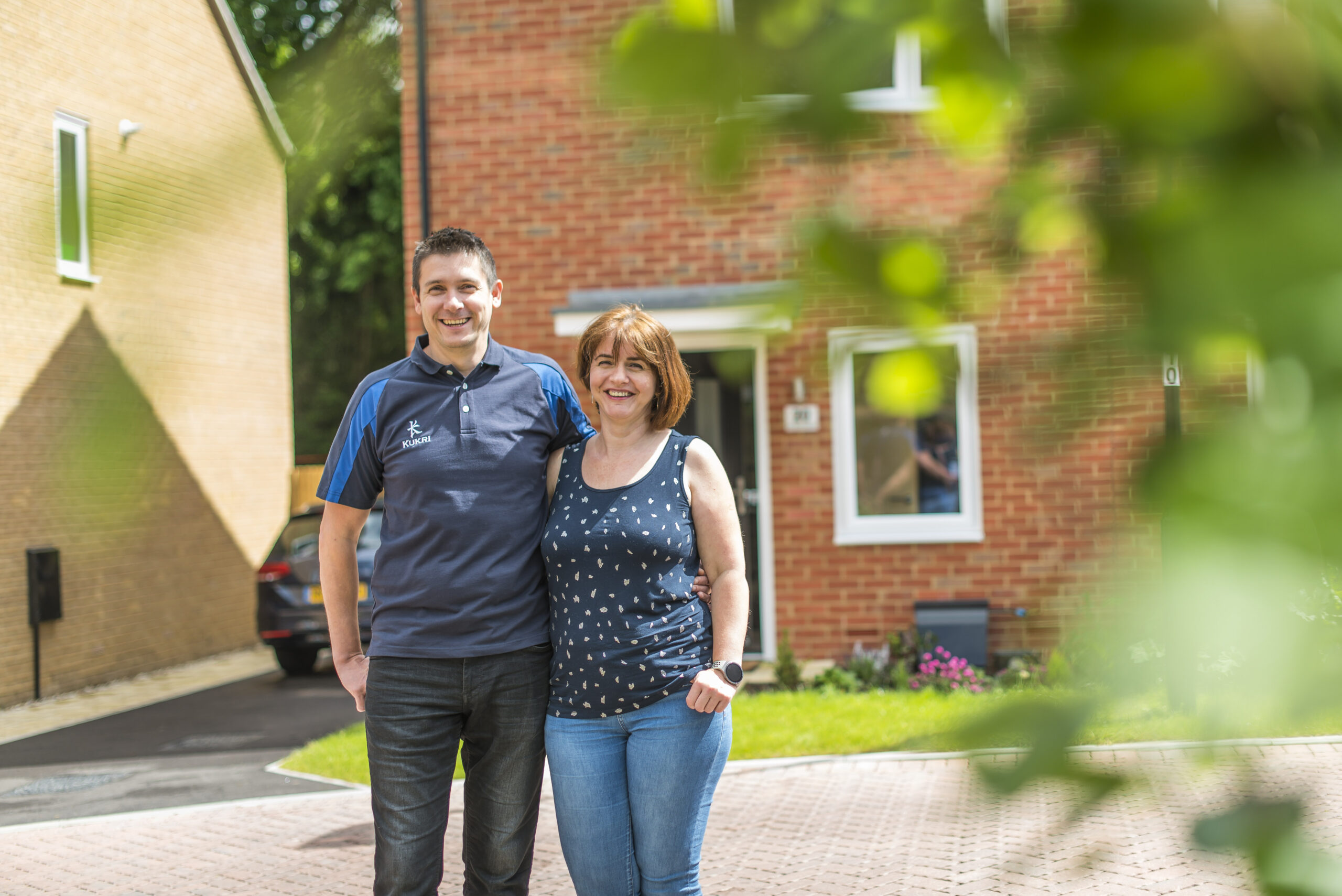 Anca and Lucian standing outside their house
