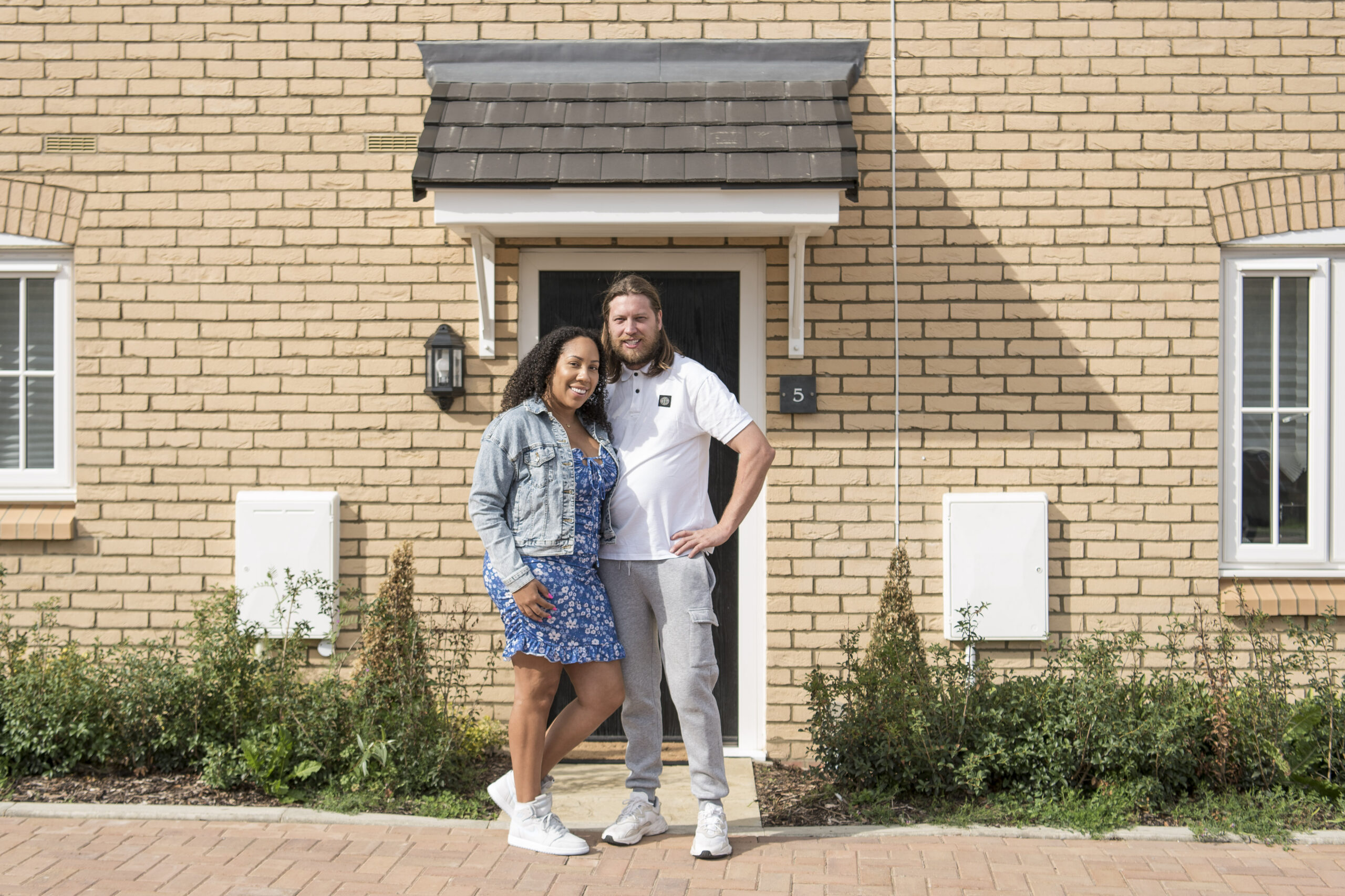 Kelly and Rhys at the front door of their home