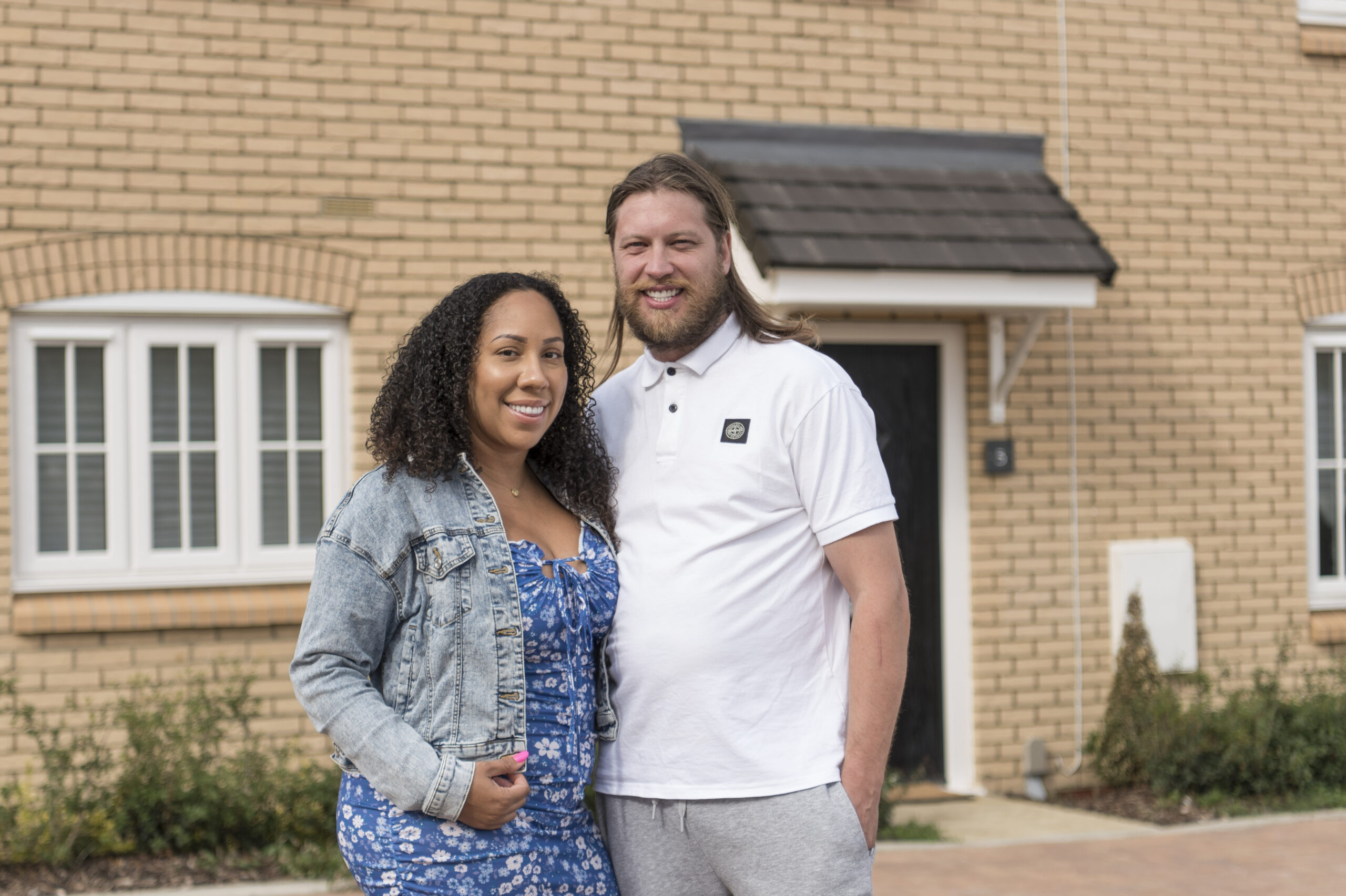 Kelly and Rhys outside their house