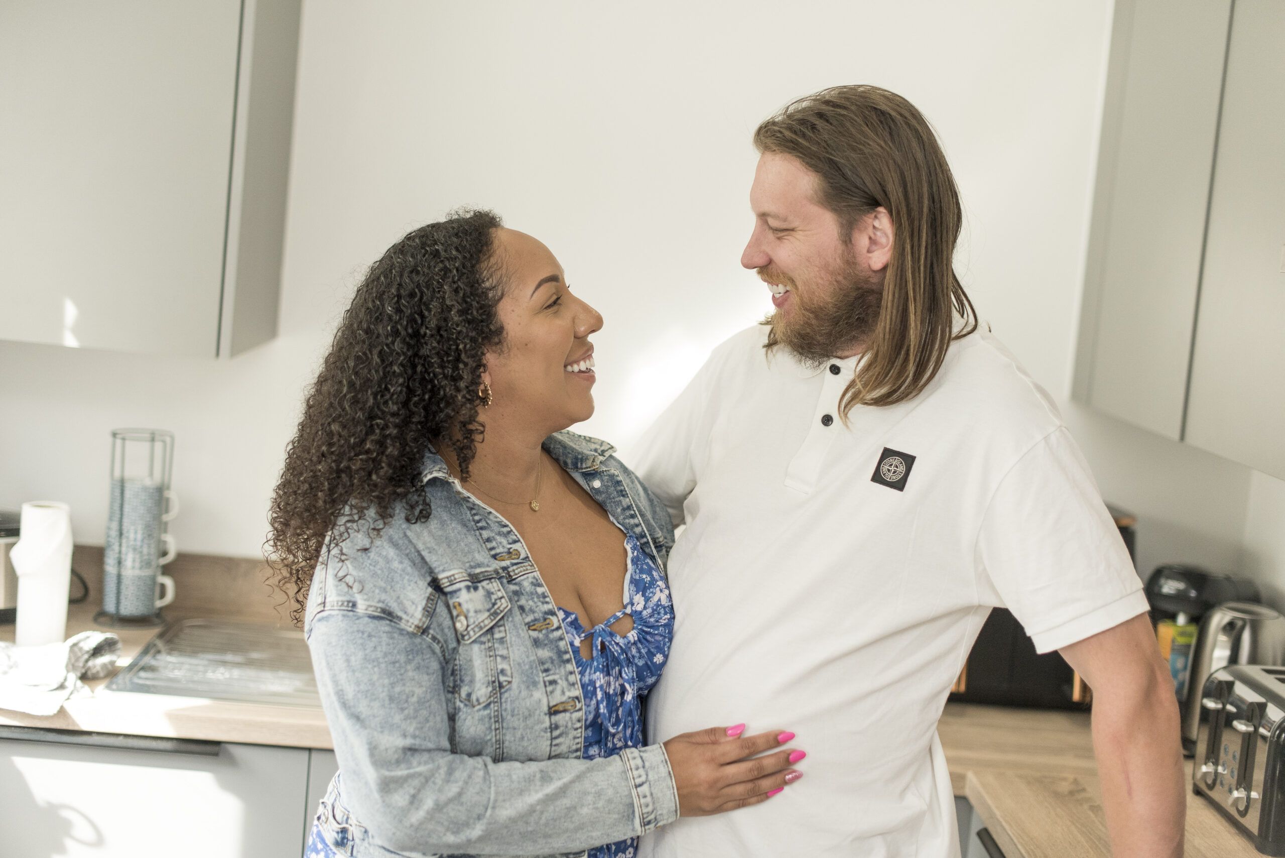 Kelly and Rhys laughing together indoors