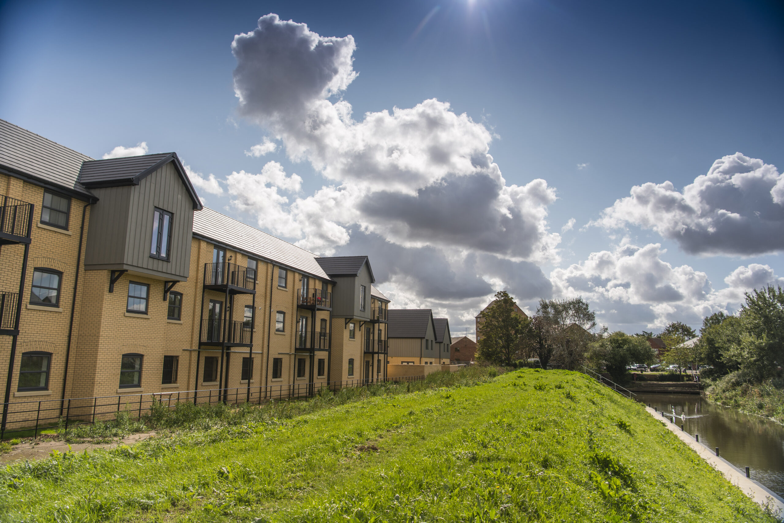 Apartment buildings beside a grassy embankment