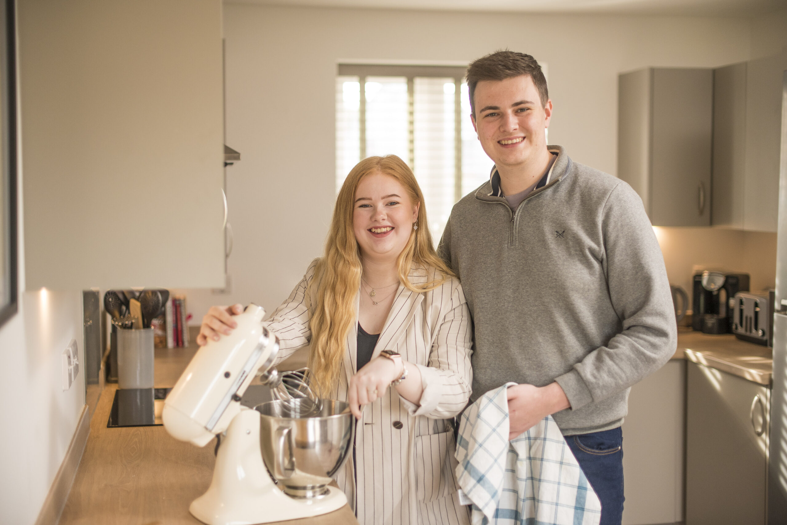 Sam and Emma in their kitchen with a stand mixer