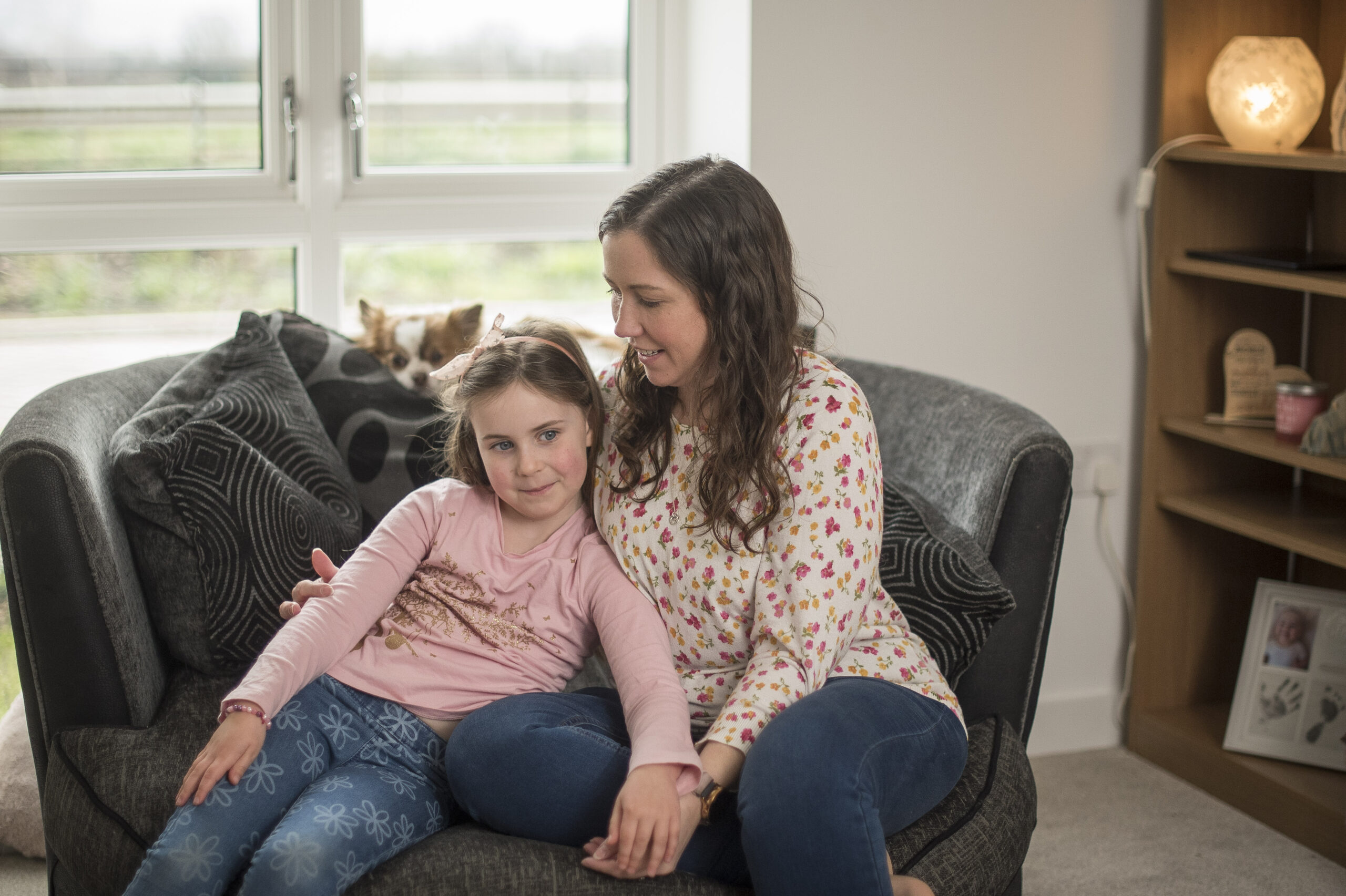 Stevie with her daughter and dog on the sofa