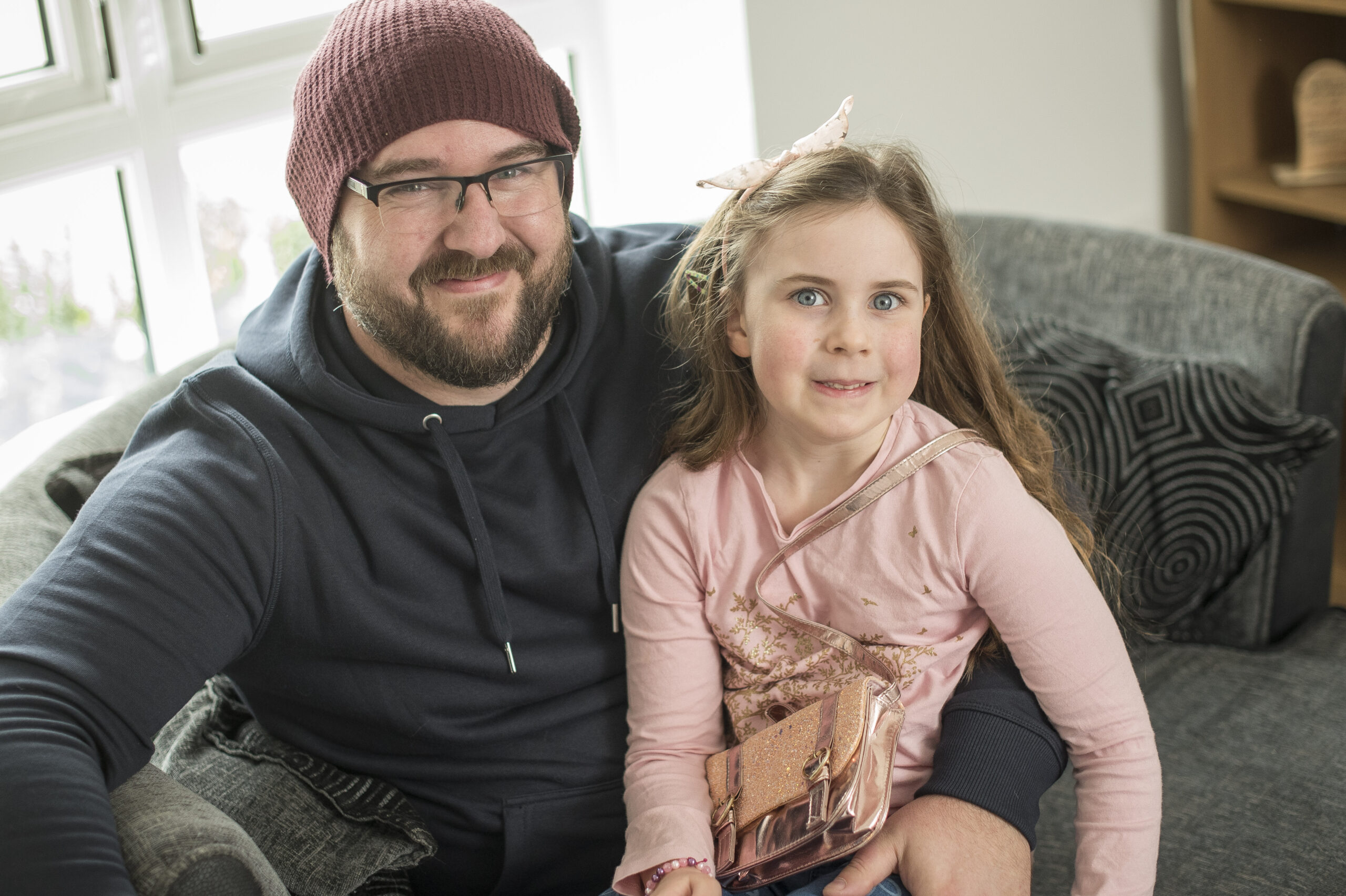 Luke sitting with his daughter