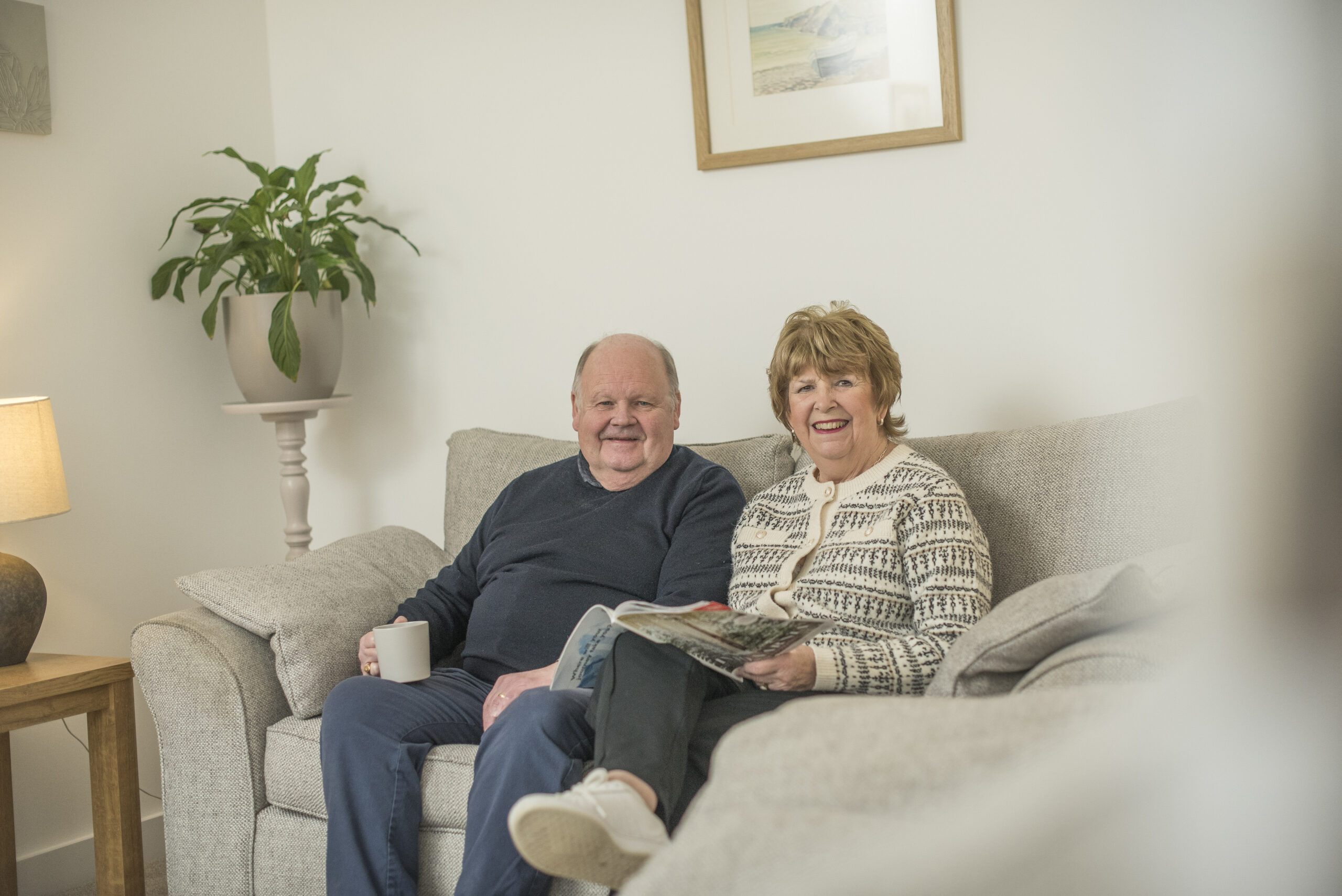 Steven and Ann sitting on their sofa