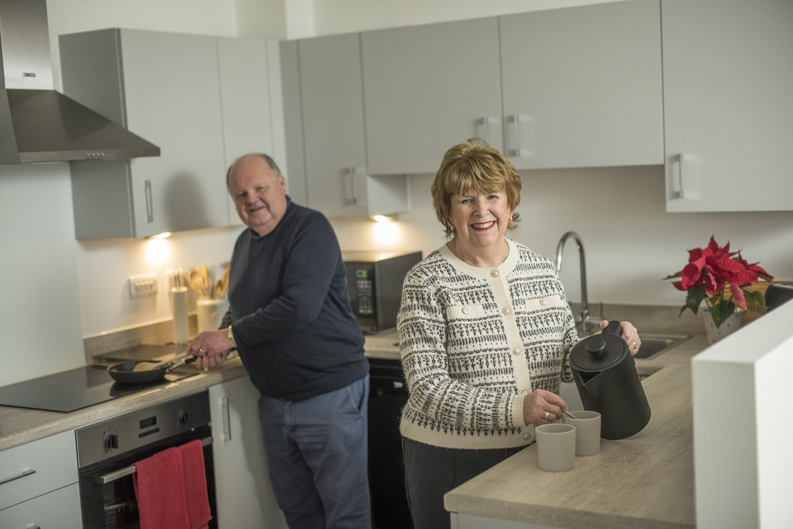Steven and Ann making drinks in their kitchen