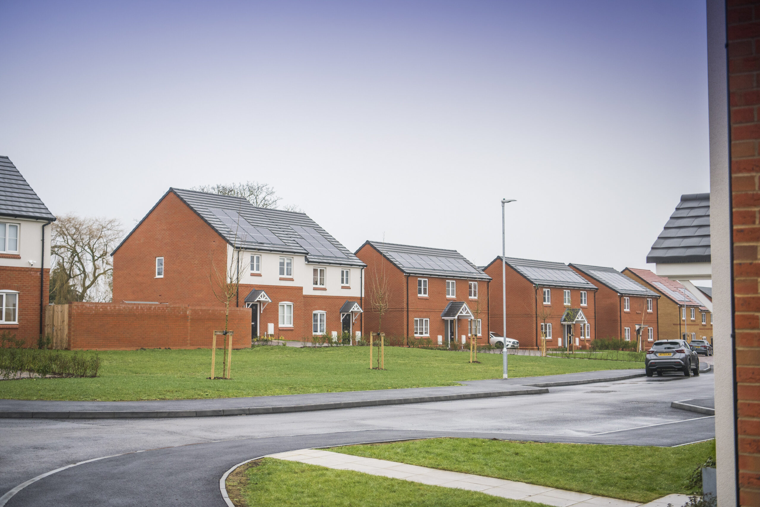 Street view of red-brick houses at the development