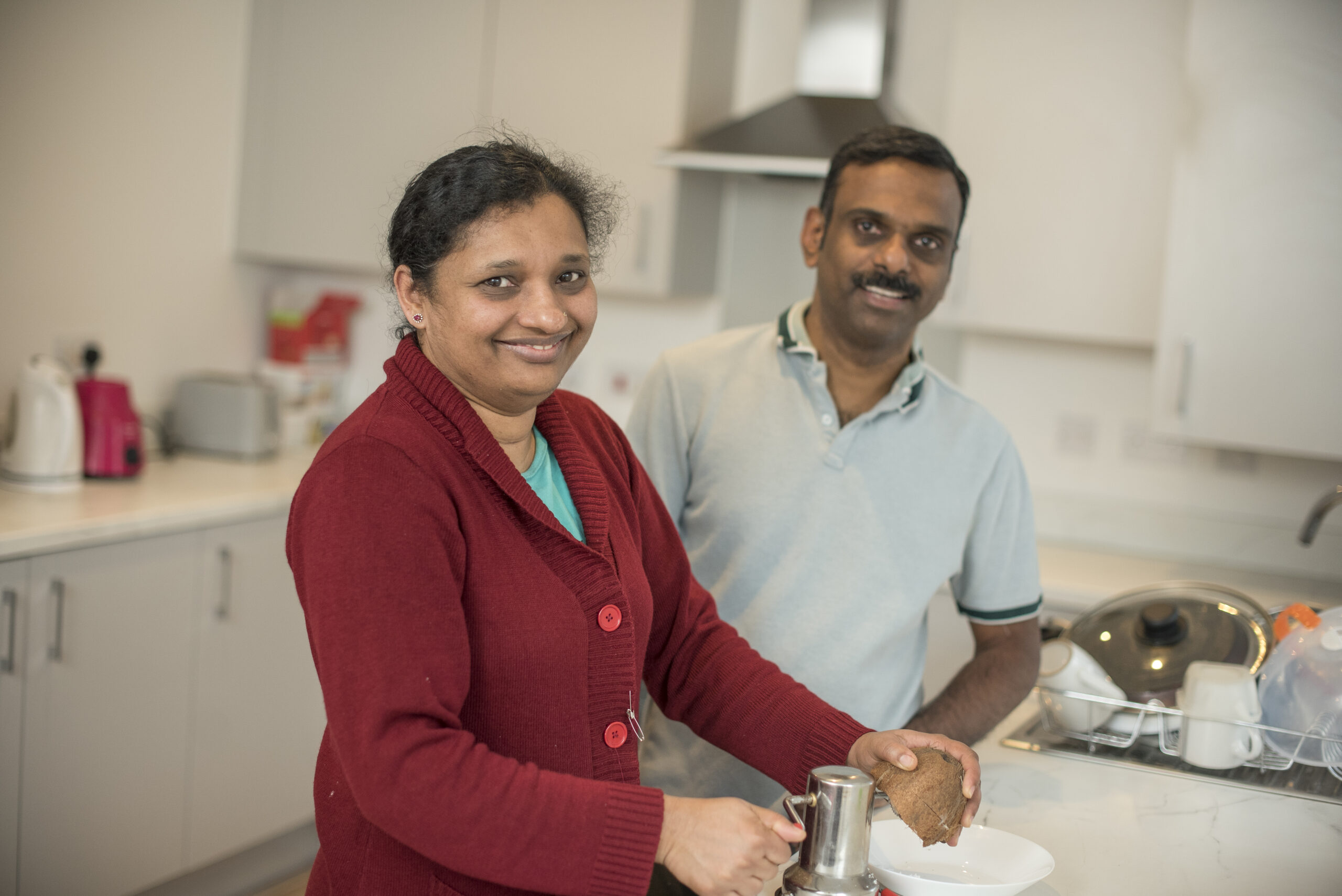 Siby and Merin in the kitchen of their home