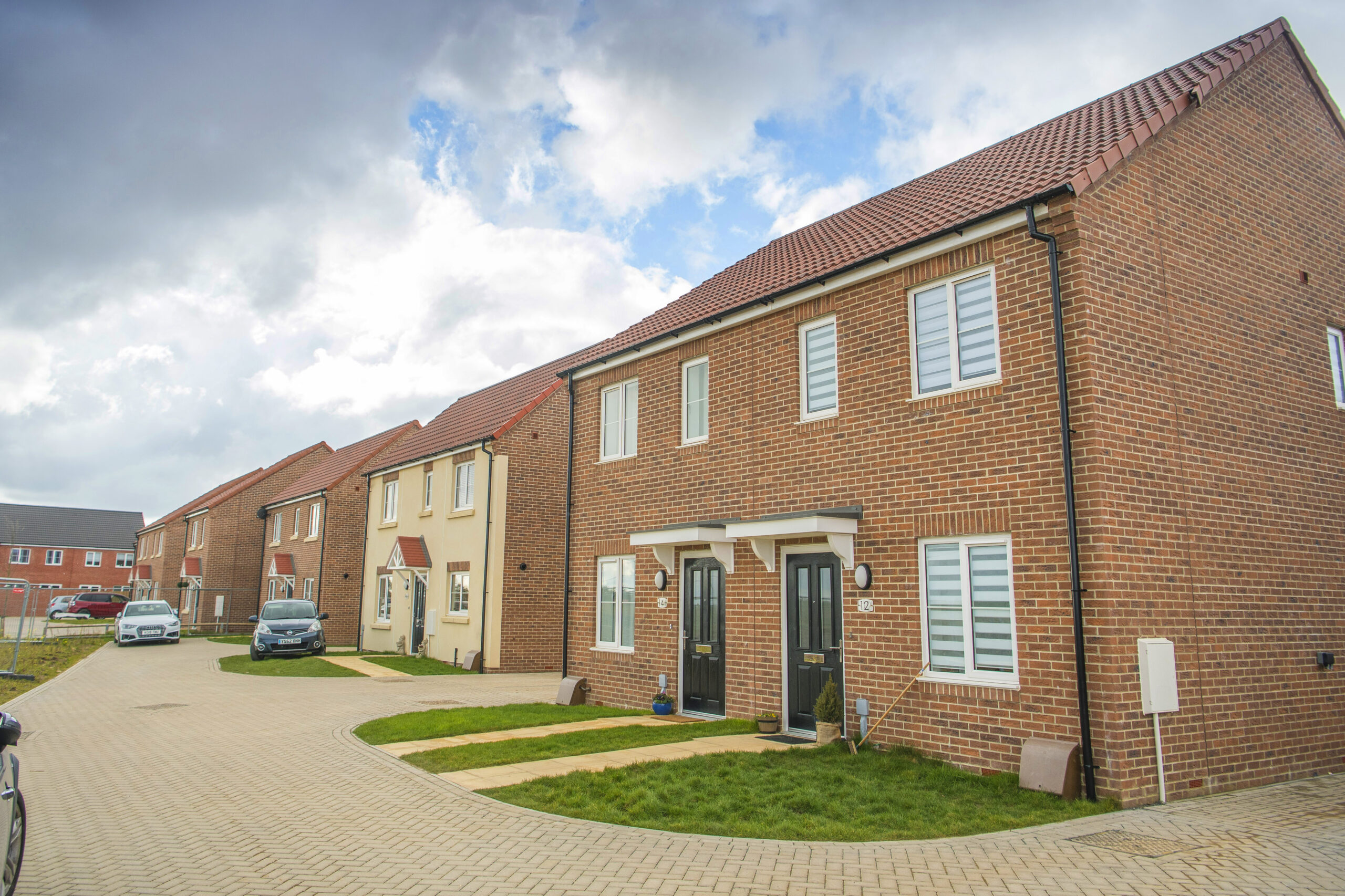 Street of new-build brick houses at the development