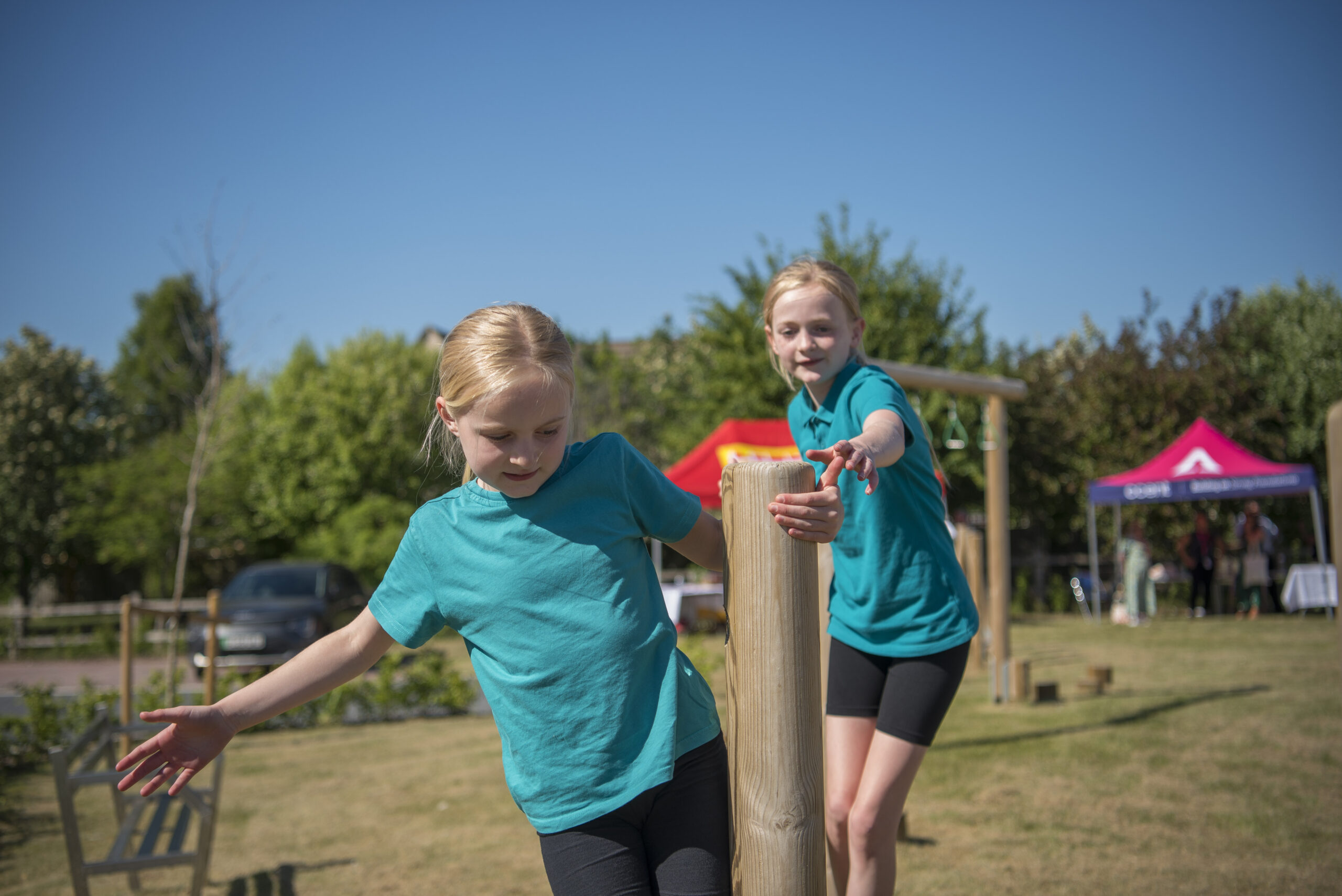 Two girls playing at an outdoor play area