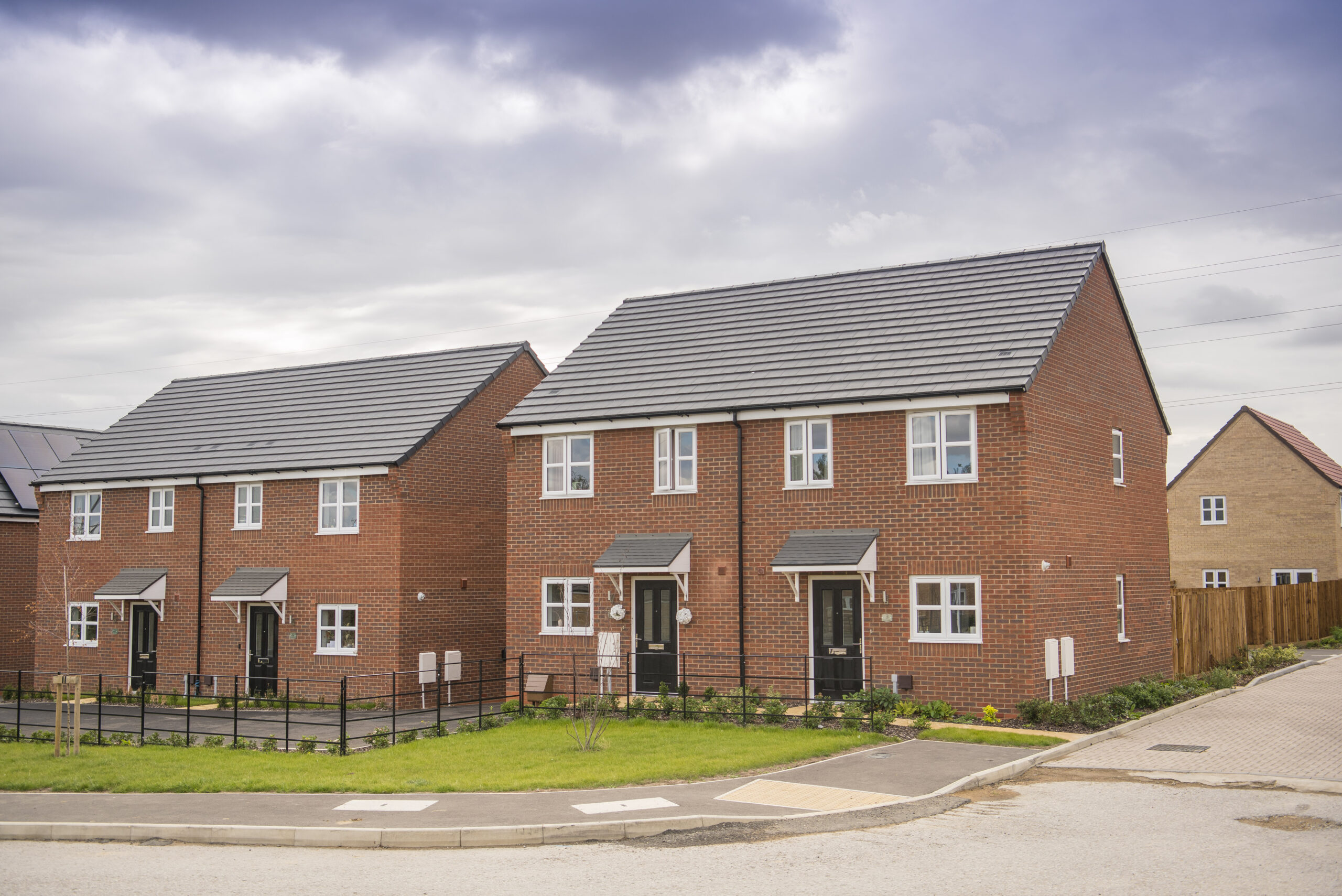 Street of new-build brick semi-detached houses