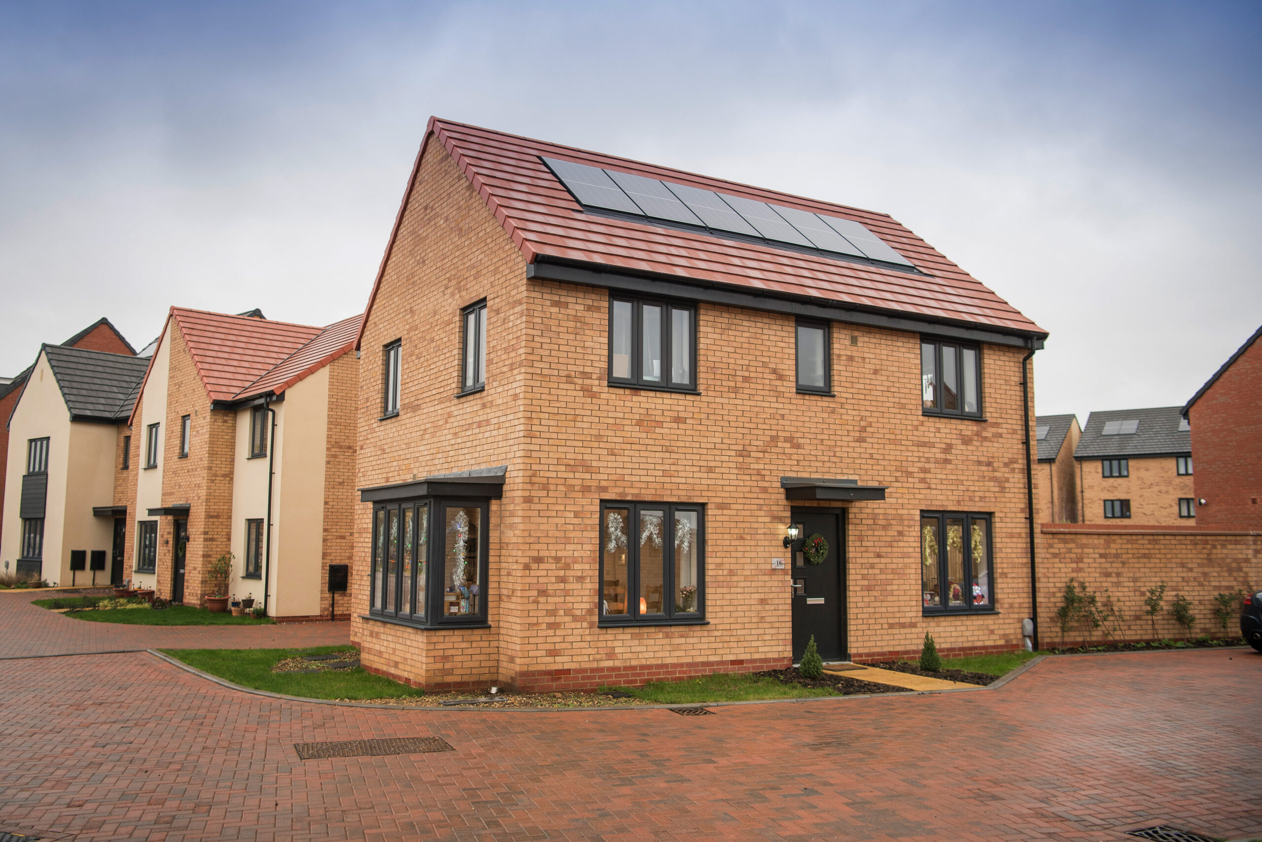 Street of new-build brick houses with solar panels